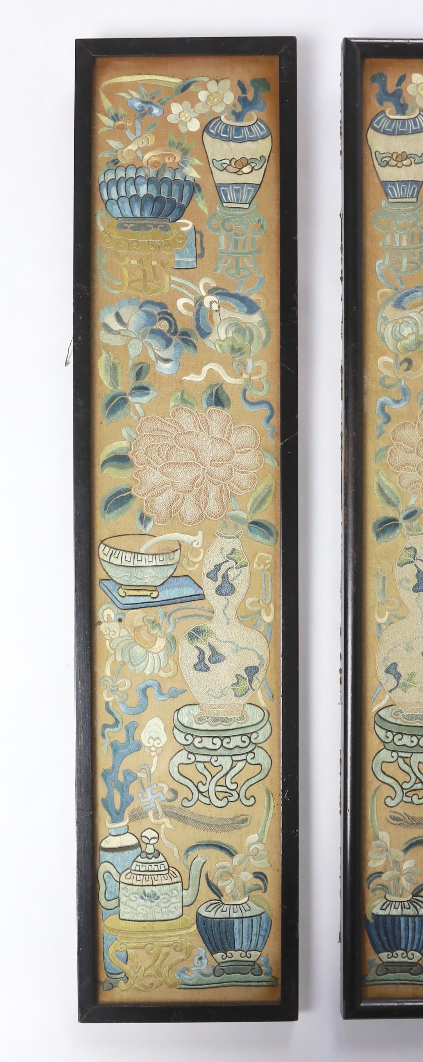 A pair of late 19th century / early 20th century Chinese silk embroidered sleeve bands, embroidered mostly with Chinese knot and stem stitch with unusual auspicious symbols each, 9.5cm wide x 49.5cm high (framed separate